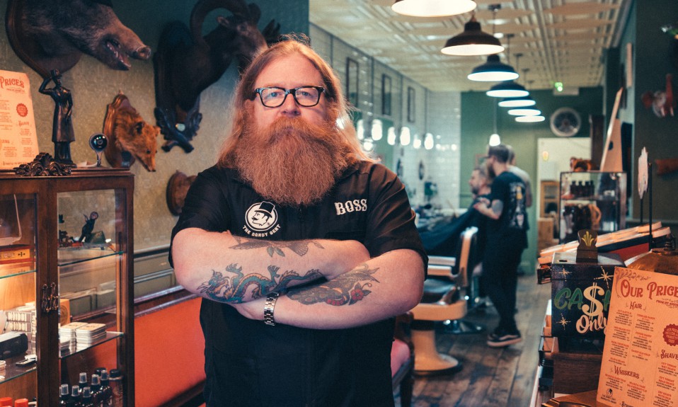 Shane O'Shaughnessy of The Dandy Gent stands in front of his barbershop in Darby