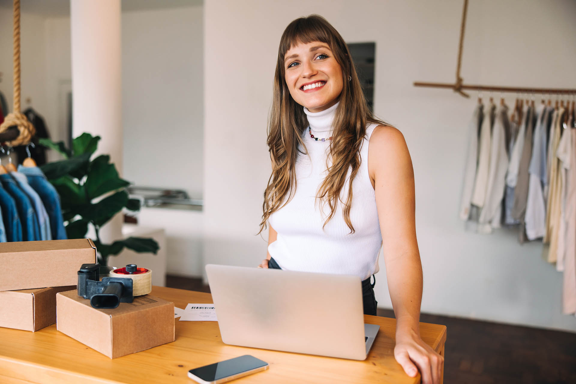 Online store owner looking away thoughtfully in her shop
